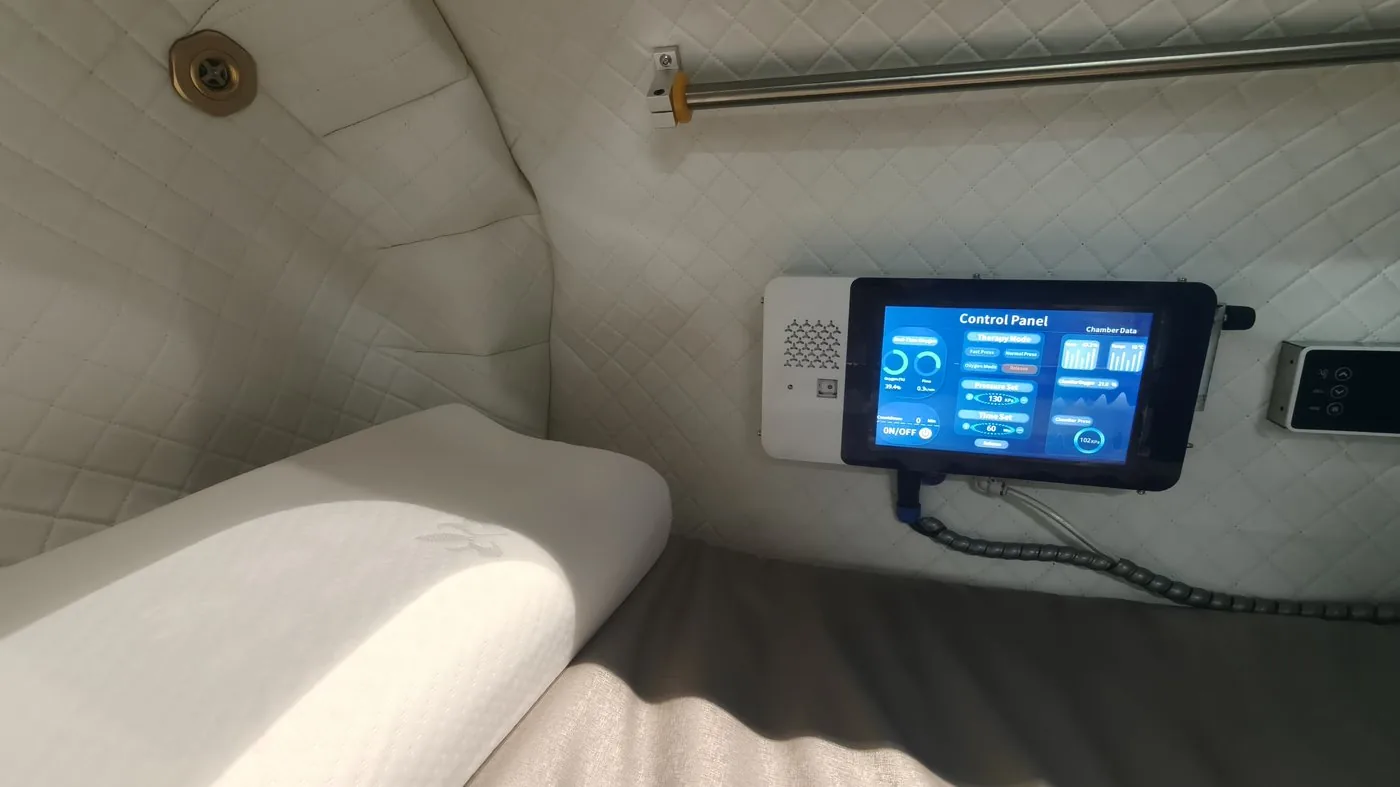 Hyperbaric chamber interior with recliner and control panel